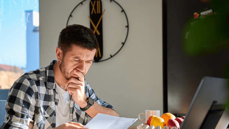 A homeowner reviewing water test results at a kitchen table, representing the informed buying decision process for home water treatment systems