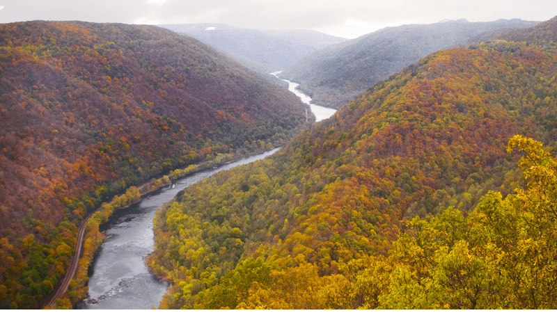 A calm Appalachian river flowing past a tree-lined bank in East Tennessee.