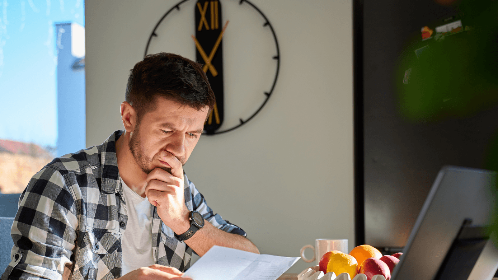 A homeowner reviewing water test results at a kitchen table, representing the informed buying decision process for home water treatment systems